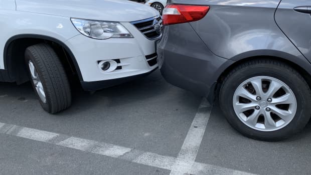 Two cars next to each other. Cars are parked very close. Small clearance from bumper to bumper. Irpen, Kiev region, supermarket parking, August 23, 2020.